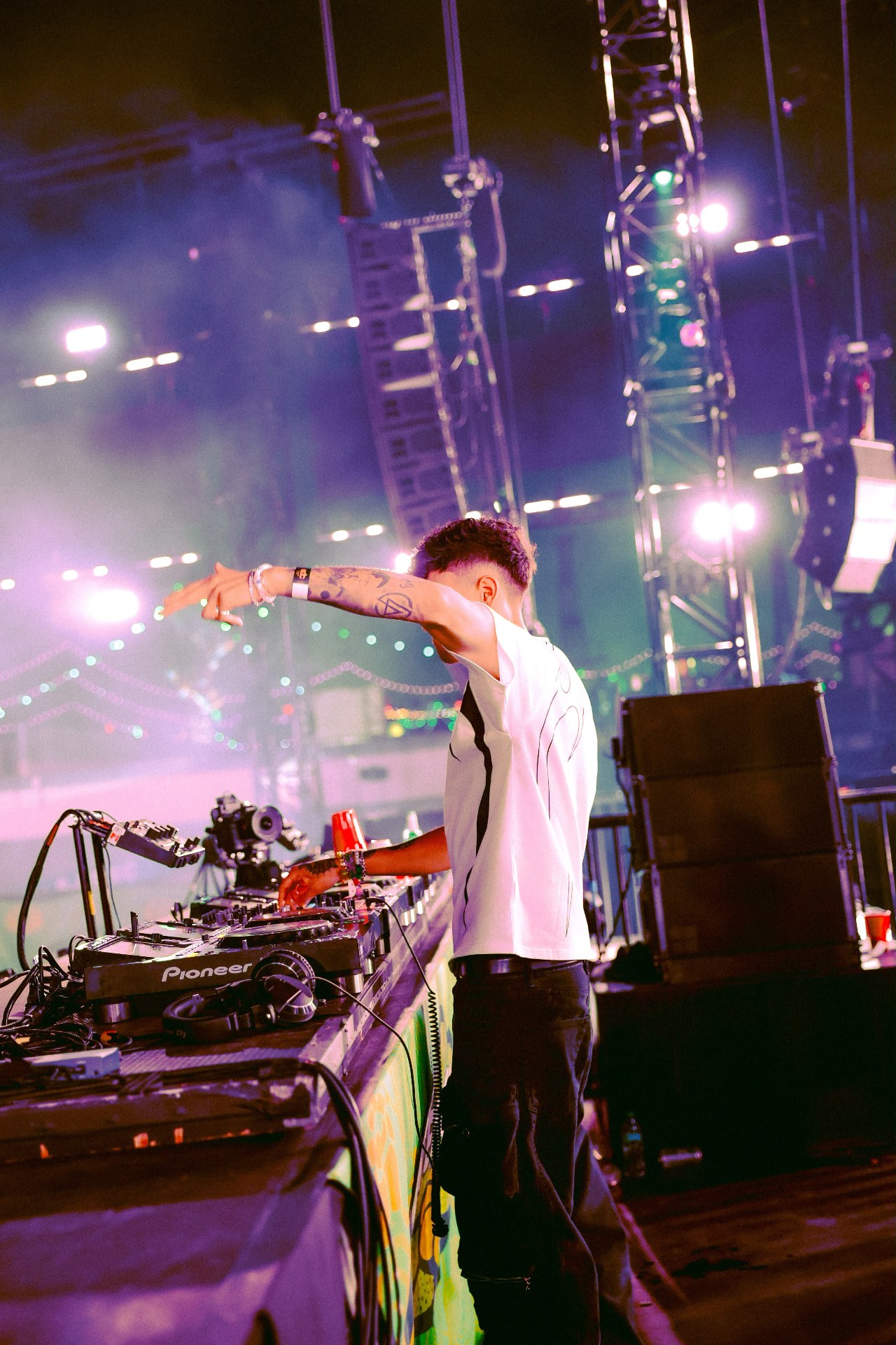 Mattilo performing from the Beatbox Art Car DJ booth at EDC Las Vegas, stage trusses and lights behind him