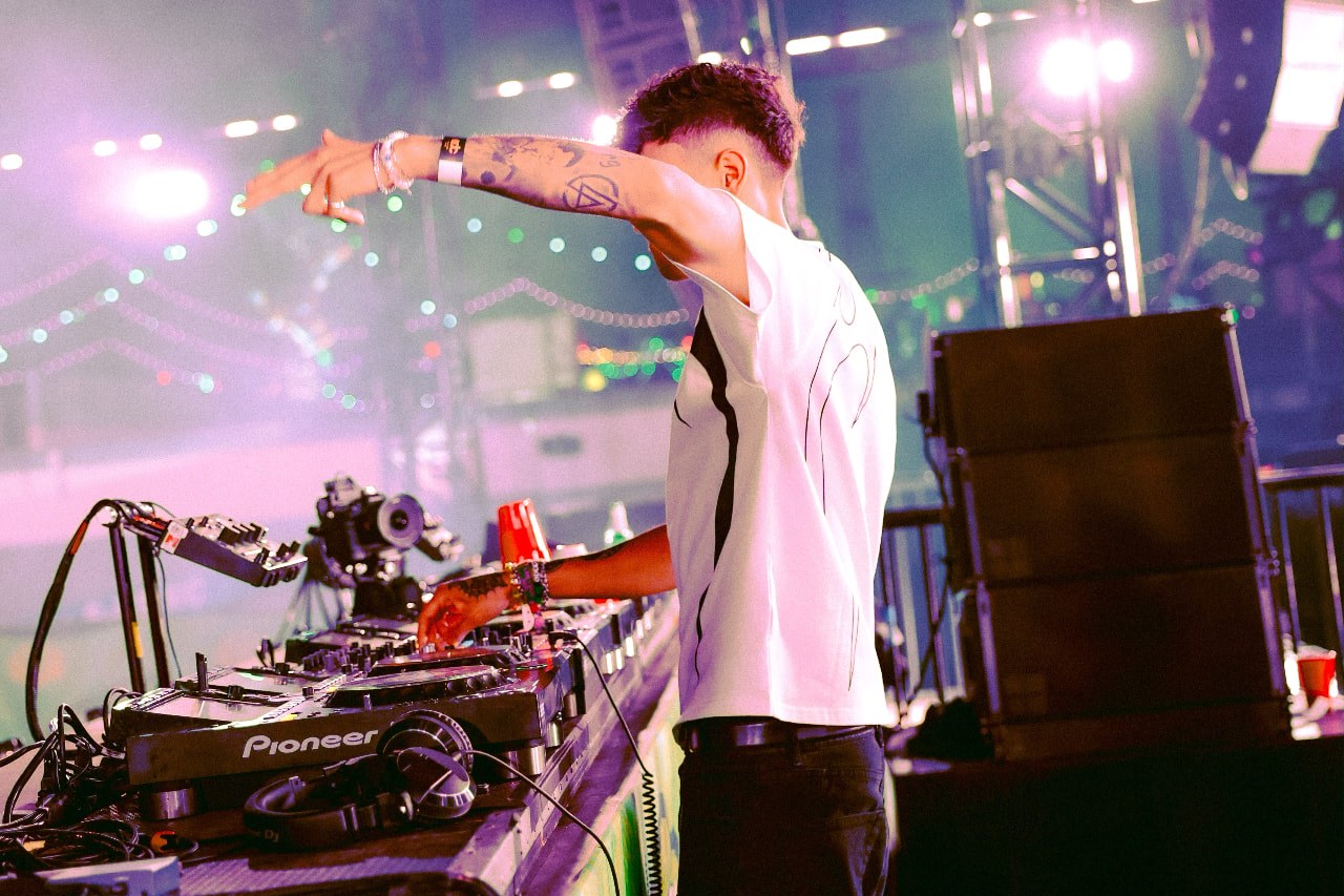 Mattilo at the DJ booth on the Beatbox Art Car at EDC Las Vegas, pointing out to the crowd